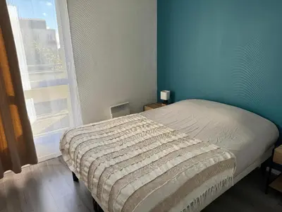 Un ou plusieurs lits dans un hébergement de l'établissement Appartement Sully
