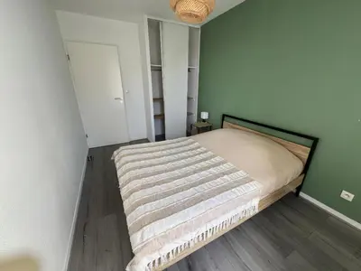 Un ou plusieurs lits dans un hébergement de l'établissement Appartement Sully