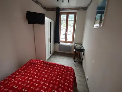 Un ou plusieurs lits dans un hébergement de l'établissement Appartement Au Cœur du Village