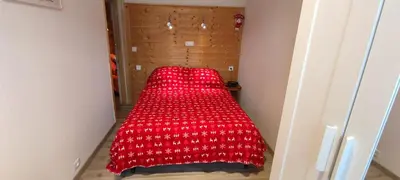 Un ou plusieurs lits dans un hébergement de l'établissement Appartement Au Cœur du Village