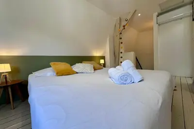Un ou plusieurs lits dans un hébergement de l'établissement Casa Majour - Duplex coeur de ville - T2 - Climatisé