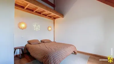 Un ou plusieurs lits dans un hébergement de l'établissement Chalet Joie