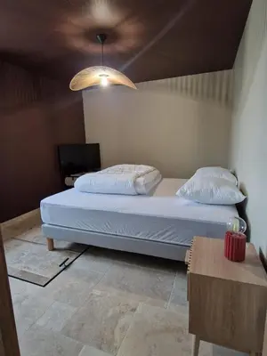 Un ou plusieurs lits dans un hébergement de l'établissement La Maison du Peuch