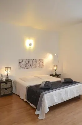 Un ou plusieurs lits dans un hébergement de l'établissement Chambre d'hôtes au Domaine de la Moretie