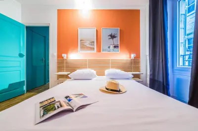 Un ou plusieurs lits dans un hébergement de l'établissement L'Indigo - 1 Chambre