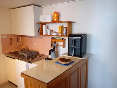 Cuisine ou kitchenette dans l'établissement Location saisonnière