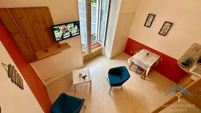Télévision ou salle de divertissement dans l'établissement Les Ambassadeurs 106 La Bourboule