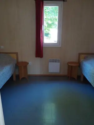 Un ou plusieurs lits dans un hébergement de l'établissement Adapted chalet