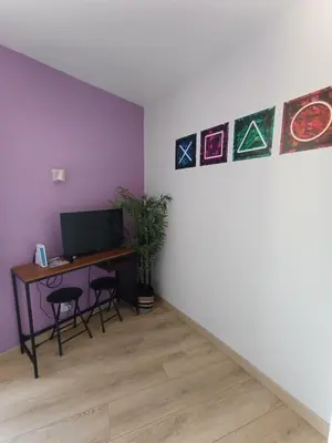 Télévision ou salle de divertissement dans l'établissement Le Nid du Haut