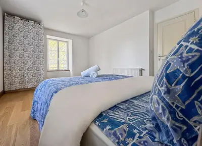 Un ou plusieurs lits dans un hébergement de l'établissement Maison de caractère au cœur du Périgord