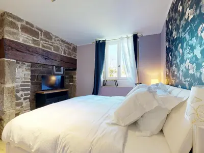 Un ou plusieurs lits dans un hébergement de l'établissement Cosy Avec Sauna et Spa Privatif