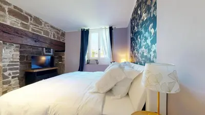 Un ou plusieurs lits dans un hébergement de l'établissement Cosy Avec Sauna et Spa Privatif