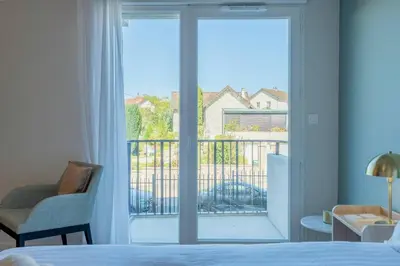 Un ou plusieurs lits dans un hébergement de l'établissement Quality Aparthotel Limoges
