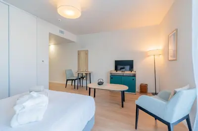 Un ou plusieurs lits dans un hébergement de l'établissement Quality Aparthotel Limoges