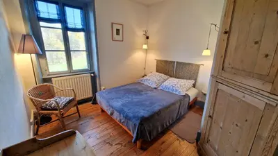 Un ou plusieurs lits dans un hébergement de l'établissement Chambres d'hôtes La Marche des Bois