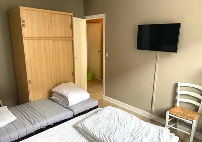 Un ou plusieurs lits dans un hébergement de l'établissement Agréable appartement au coeur du Mont-dore
