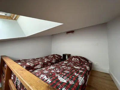 Un ou plusieurs lits dans un hébergement de l'établissement Appartement esprit montagne