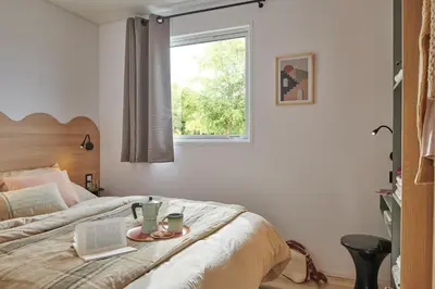 Un ou plusieurs lits dans un hébergement de l'établissement Camping O'Aka