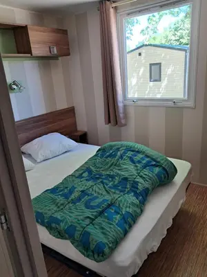 Un ou plusieurs lits dans un hébergement de l'établissement Mobilhome au bord du lac avec piscine