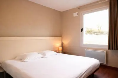 Un ou plusieurs lits dans un hébergement de l'établissement Les Balcons du Sancy - Résidence 3 étoiles