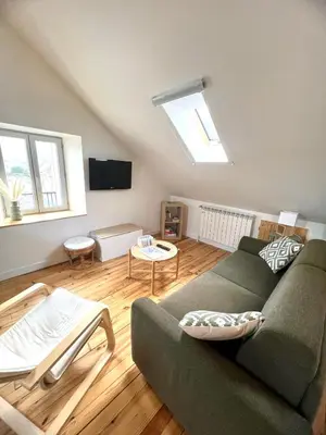 Télévision ou salle de divertissement dans l'établissement Appartement Le Dôme-Vue sur les montagnes