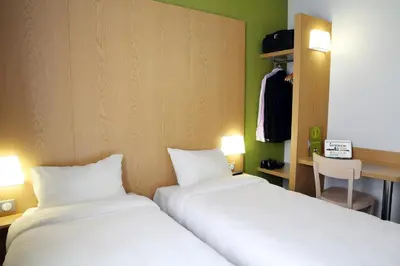 Un ou plusieurs lits dans un hébergement de l'établissement B&B HOTEL Brive-la-Gaillarde