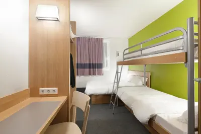 Un ou plusieurs lits dans un hébergement de l'établissement B&B HOTEL Brive-la-Gaillarde