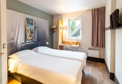 Un ou plusieurs lits dans un hébergement de l'établissement B&B HOTEL Limoges 1