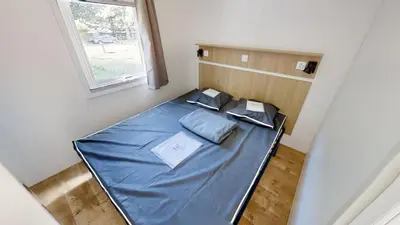 Un ou plusieurs lits dans un hébergement de l'établissement Camping Les Vernieres La Bourboule Sancy