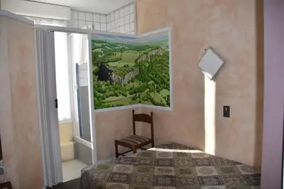 Un ou plusieurs lits dans un hébergement de l'établissement Hôtel Le Rider