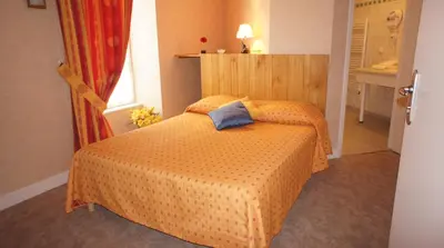 Un ou plusieurs lits dans un hébergement de l'établissement Auberge De Raulhac