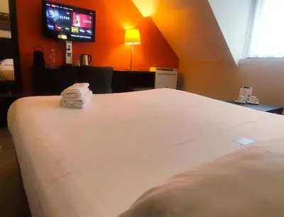 Un ou plusieurs lits dans un hébergement de l'établissement Contact Hotel B&G Limoges Sud