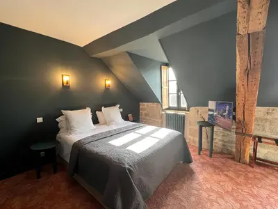 Un ou plusieurs lits dans un hébergement de l'établissement Hôtel Le France