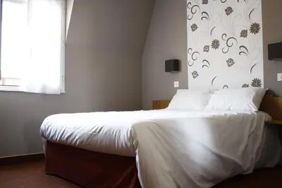 Un ou plusieurs lits dans un hébergement de l'établissement Hotel du Touring