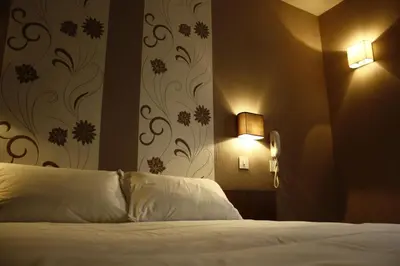 Un ou plusieurs lits dans un hébergement de l'établissement Hotel du Touring