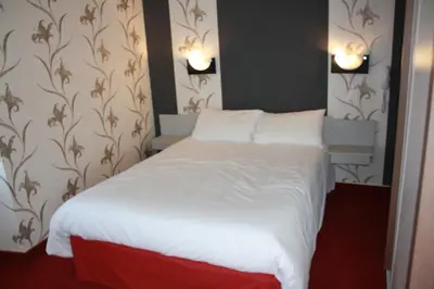 Un ou plusieurs lits dans un hébergement de l'établissement Hotel du Touring