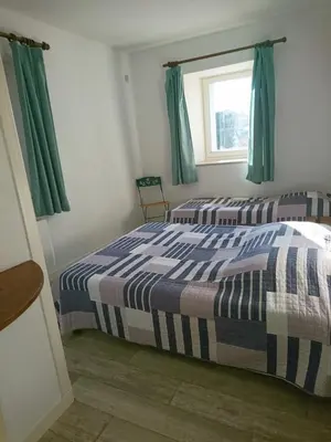 Un ou plusieurs lits dans un hébergement de l'établissement Les Appartements de Johann