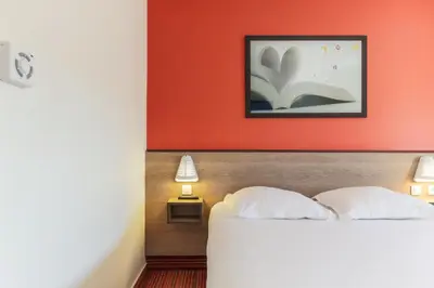 Un ou plusieurs lits dans un hébergement de l'établissement Ace Hotel Brive