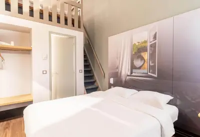 Un ou plusieurs lits dans un hébergement de l'établissement B&B HOTEL Limoges 2