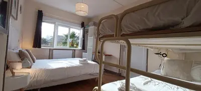 Un ou plusieurs lits dans un hébergement de l'établissement Hôtel Le P'tit Monde