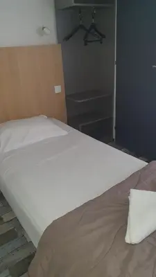 Un ou plusieurs lits dans un hébergement de l'établissement Welcomotel Limoges
