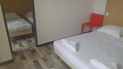Un ou plusieurs lits dans un hébergement de l'établissement Welcomotel Limoges
