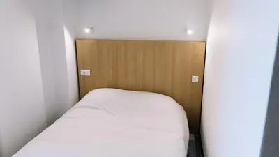 Un ou plusieurs lits dans un hébergement de l'établissement Welcomotel Limoges