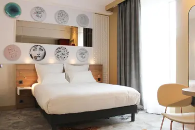 Un ou plusieurs lits dans un hébergement de l'établissement Brit Hotel Limoges Centre Gare - Hôtel & Spa