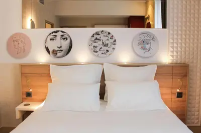Un ou plusieurs lits dans un hébergement de l'établissement Brit Hotel Limoges Centre Gare - Hôtel & Spa