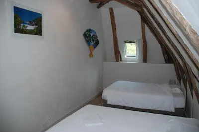 Un ou plusieurs lits dans un hébergement de l'établissement Gites Chateau le Bois