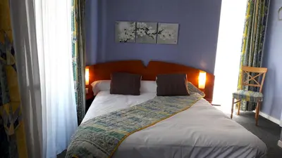 Un ou plusieurs lits dans un hébergement de l'établissement Hotel Le Saint Georges