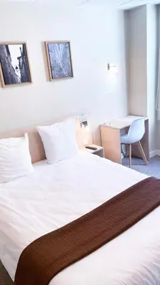 Un ou plusieurs lits dans un hébergement de l'établissement Abelha Hôtel Le France