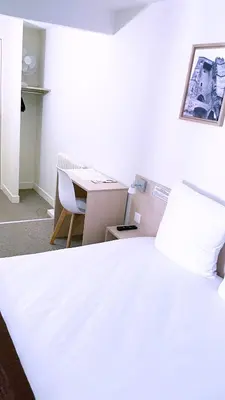 Un ou plusieurs lits dans un hébergement de l'établissement Abelha Hôtel Le France