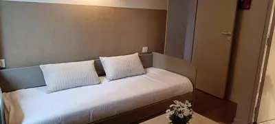 Un ou plusieurs lits dans un hébergement de l'établissement Logis Hotel Grangier
